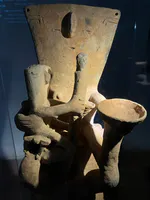 Seated Figure with Cup and Staff