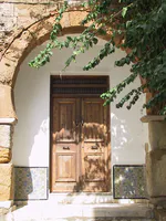 Wooden Doorway Framed by Stone and Tile