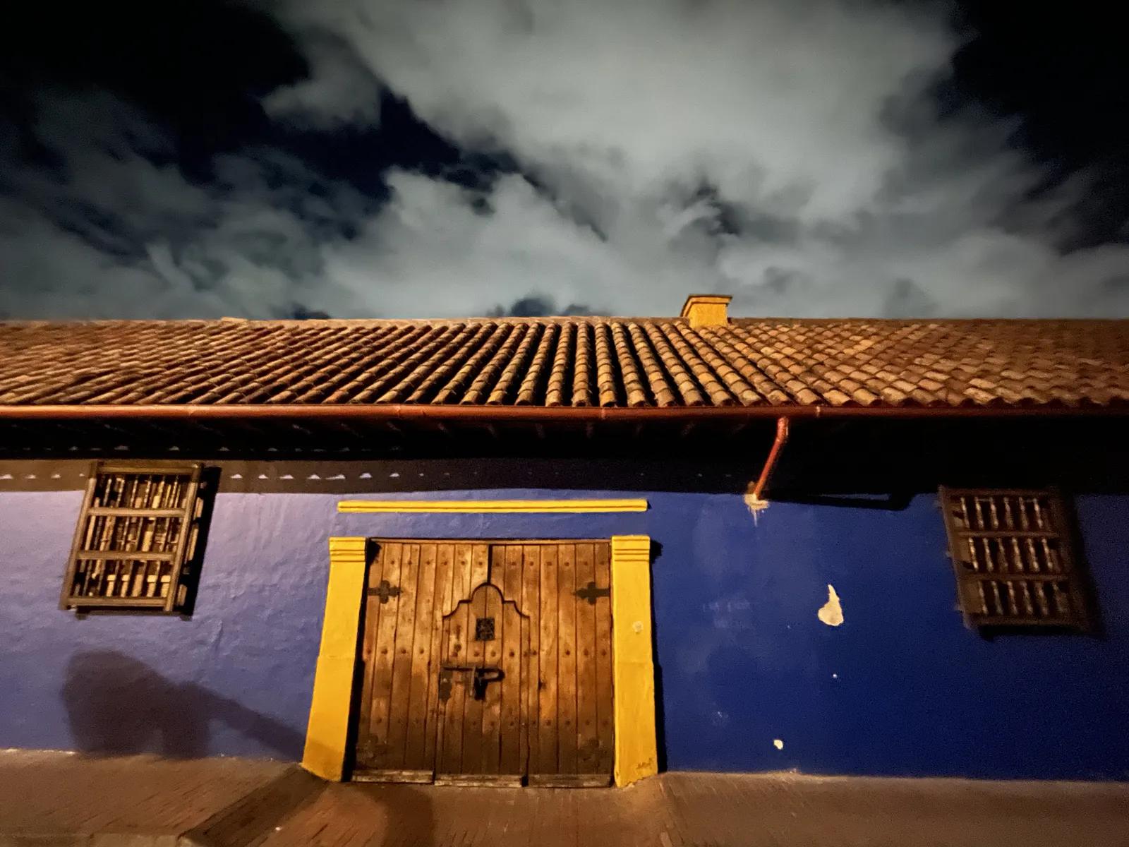 Blue Colonial Façade with Wooden Portal